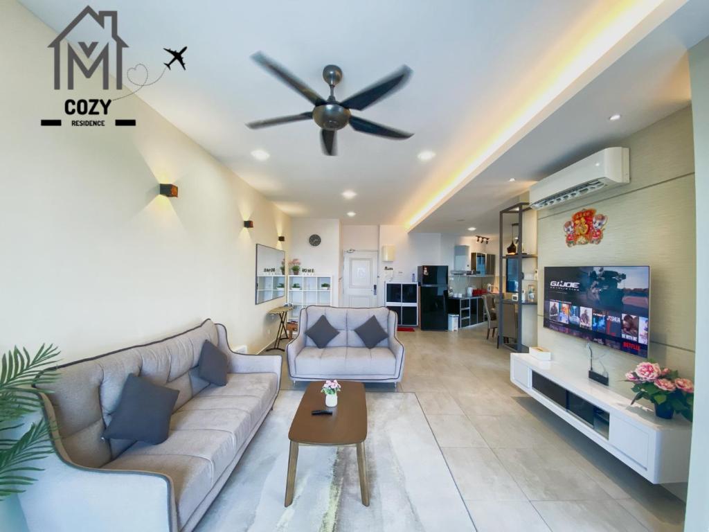 a living room with a couch and a ceiling fan at Atlantis Premium 3BDR 4-12pax/5 min to jonker/town in Melaka
