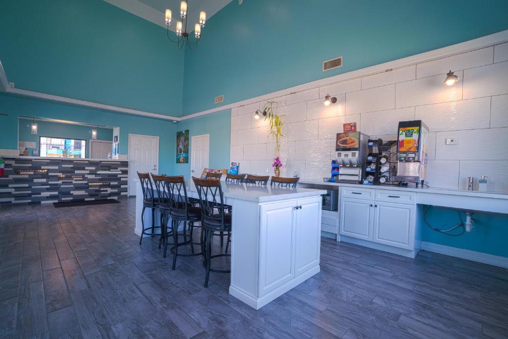 a large kitchen with a bar with stools in it at Hotel Bliss Kemah in Kemah
