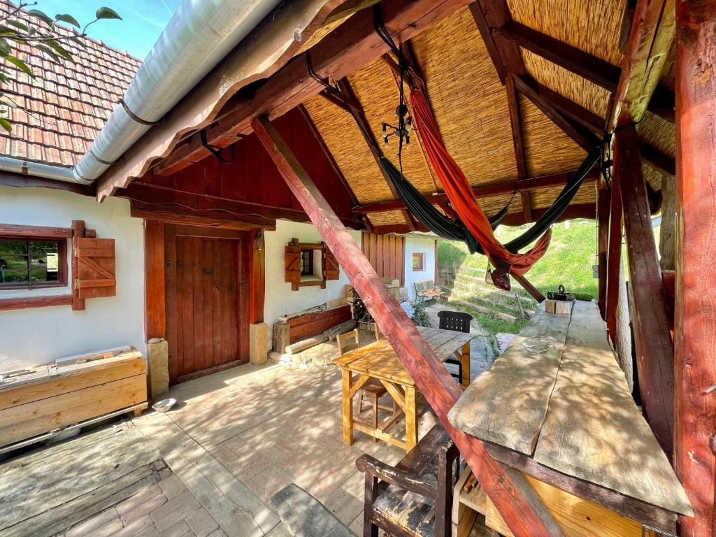 a porch of a house with a wooden roof at Nature Lodge Csesztve in Csesztve