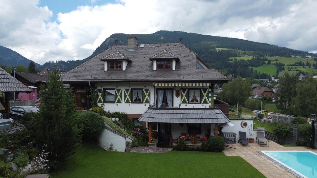 a large house with a yard and a swimming pool at Landhaus Gartler in Mauterndorf