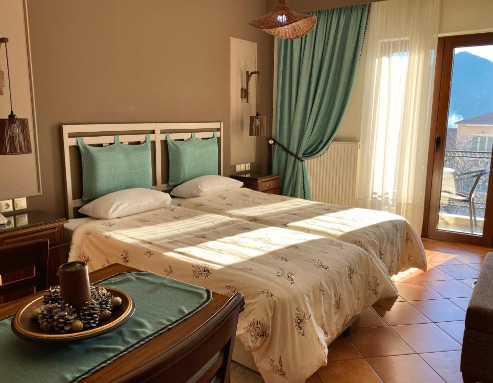 a bedroom with a large bed with a bowl of fruit on a table at Marianna's Home Accommodation in Karpenision