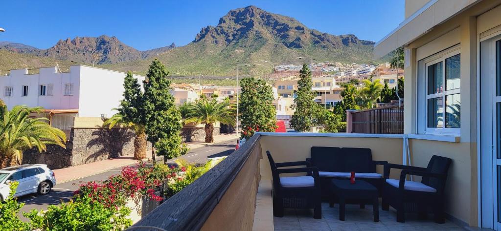 a balcony with chairs and a view of a mountain at Costa Adeje Holiday Home in Adeje