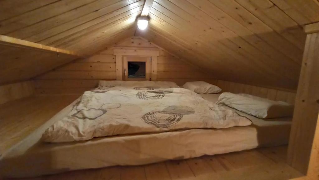 A bed or beds in a room at Happy Cottage