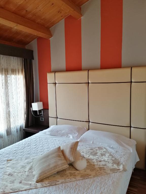 Postel nebo postele na pokoji v ubytování Albergo Minuetto
