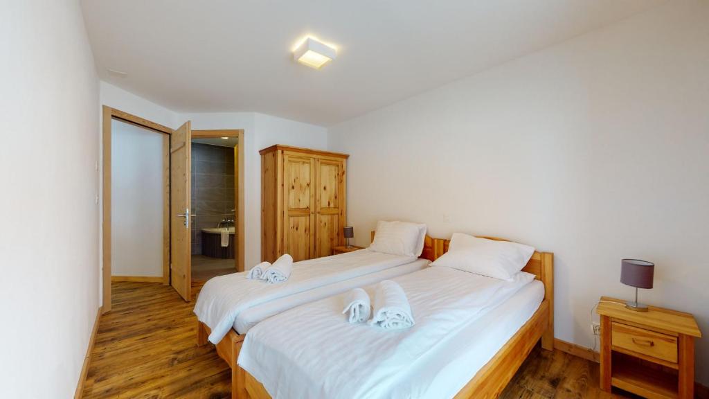 Postel nebo postele na pokoji v ubytování Les Mayens LUXURY & COSY apartments