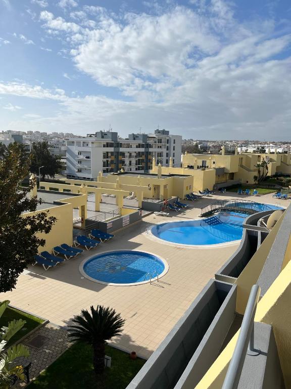 a view of a resort with two swimming pools at Condominio do Mar in Lagos