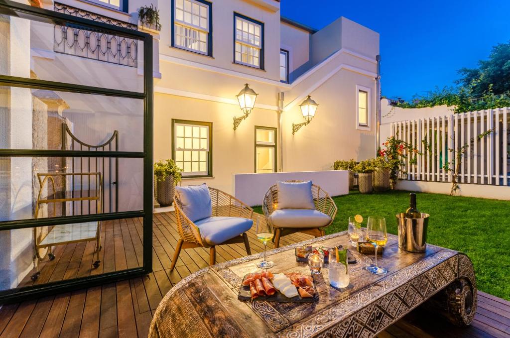 a patio with a table with food and drinks on it at BCascais Boutique House by APT IIN Cascais Center in Cascais