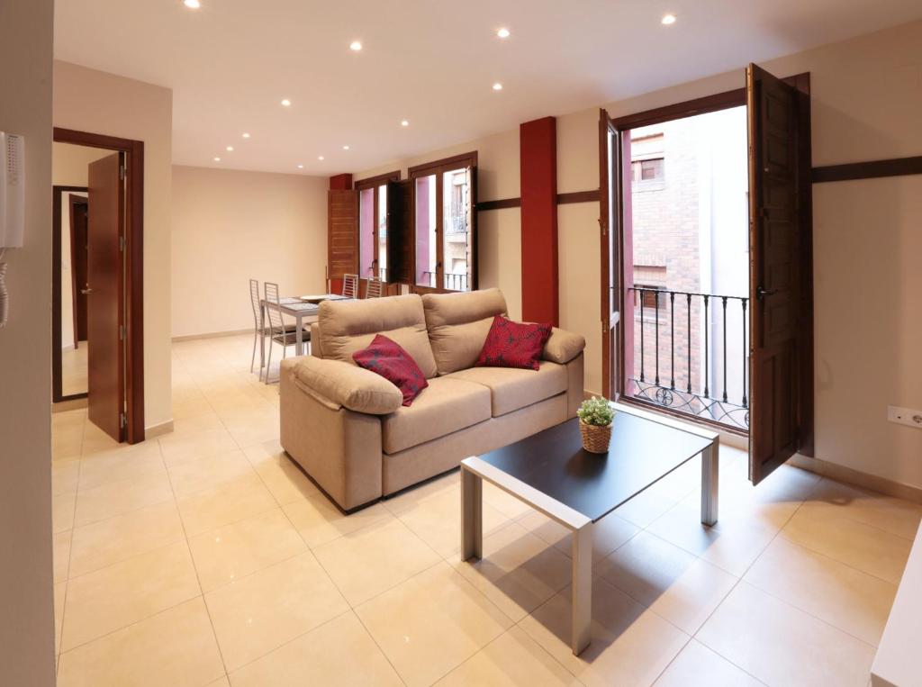sala de estar con sofá y mesa en Apartamentos Reyes Católicos, en Granada
