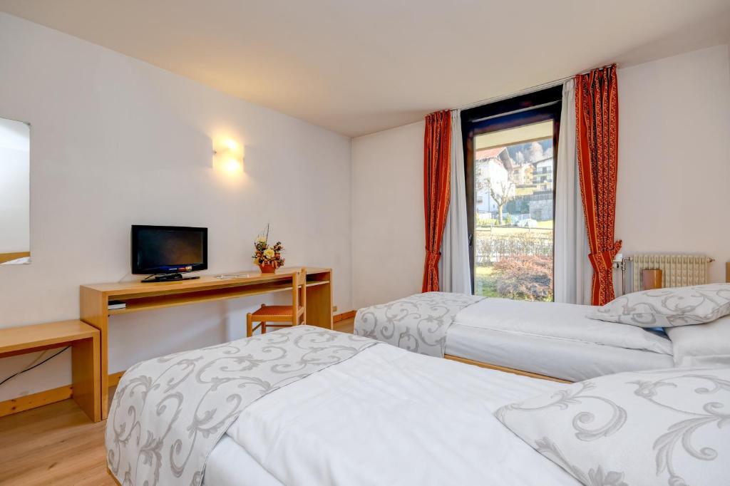Postel nebo postele na pokoji v ubytování Bepy Hotel Garni