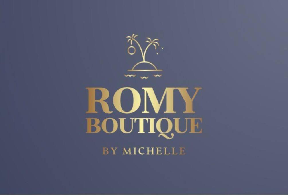 a logo for a company with palm trees on a blue background at Romy boutique in Netanya