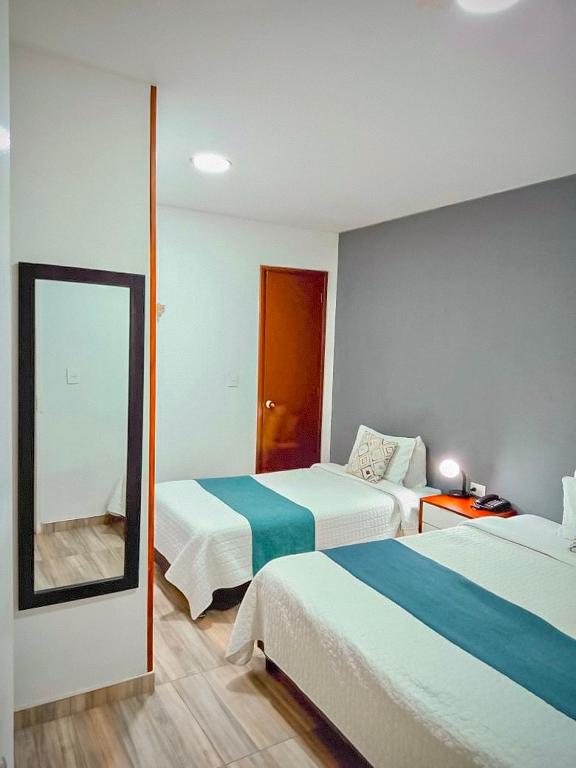 Postel nebo postele na pokoji v ubytování Hotel Maceo 55 - Colonial Inn