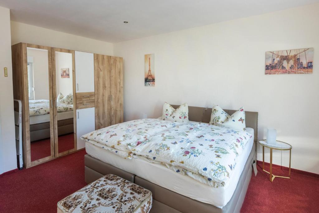 a bedroom with a large bed and a mirror at Ferienhaus Annerose in Wendisch Rietz