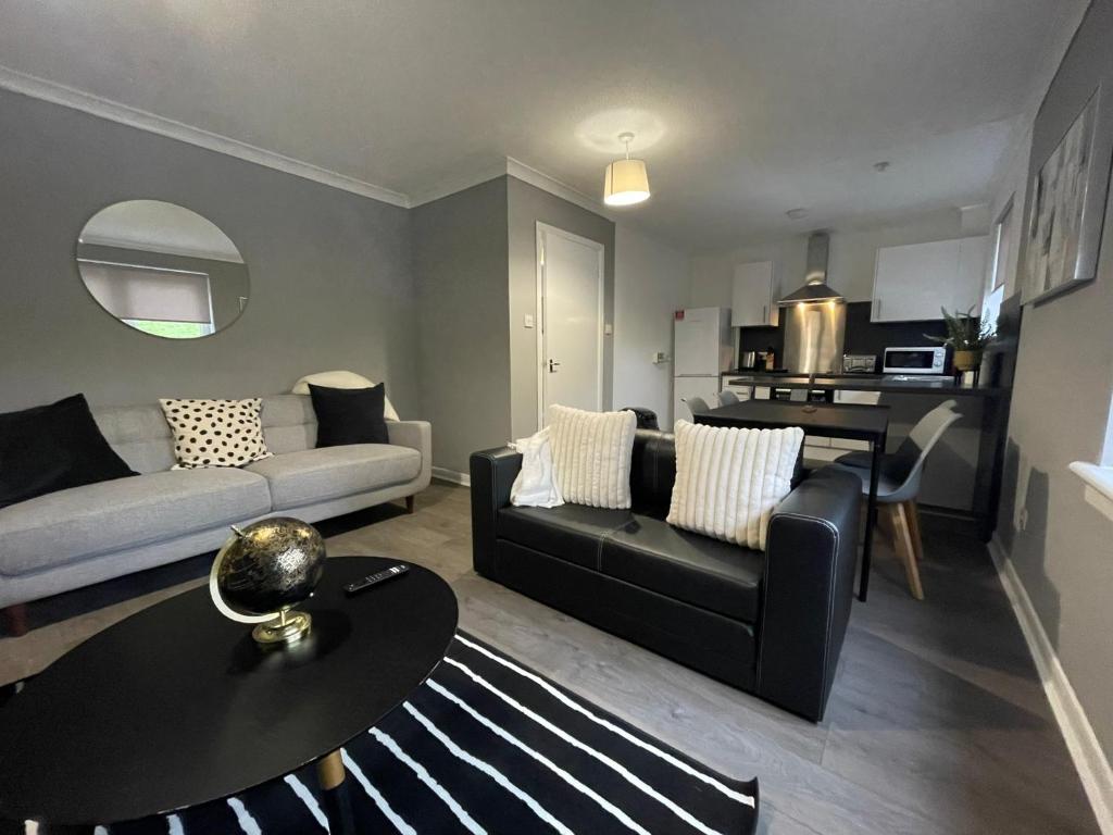 a living room with a couch and a table at Dunbeth House in Coatbridge