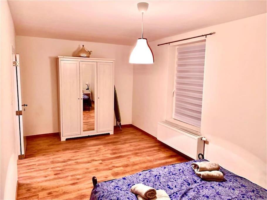 a bedroom with a bed and a large window at Maison proche du centre ville de la gare l aéroport de Charleroi in Charleroi