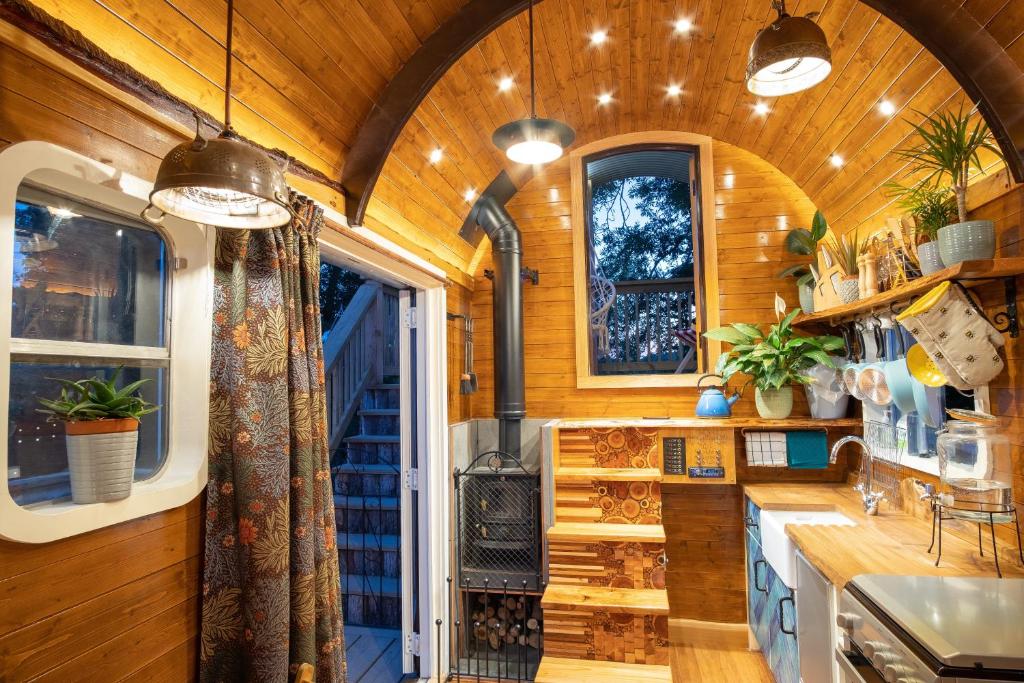 a kitchen with wooden walls and a large window at Get Away Hide Away in East Dereham