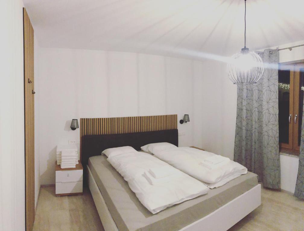 Postel nebo postele na pokoji v ubytování ALPS Apartments