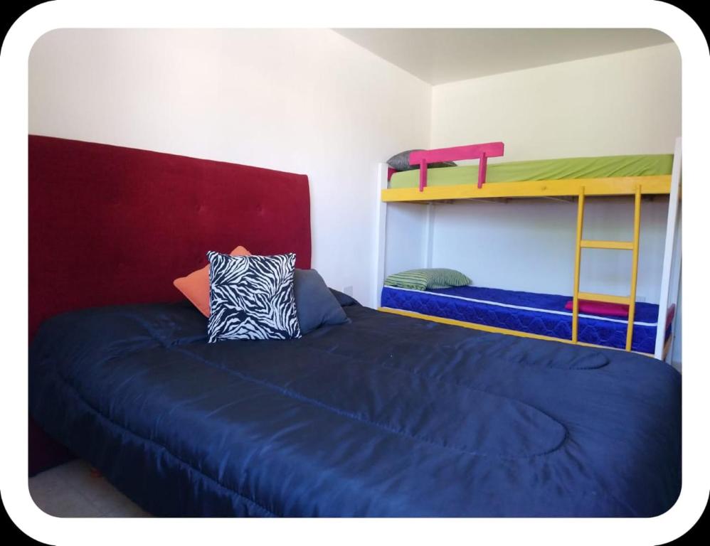 a bedroom with two bunk beds and a blue bed at el descanso in San Antonio de Areco