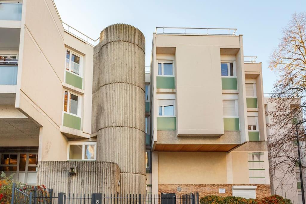 a tall building with a cylindrical building at Appart spacieux près de la Seine in Sartrouville