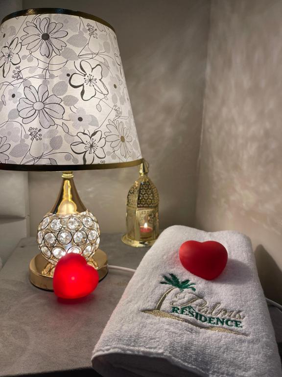 a table with a lamp and a towel with a happy valentines sign at Ideal For Families I Entire Comfy Appartment I Fibre Internet Up to 100 Mbps I PALMS Residence in Er Rachidia
