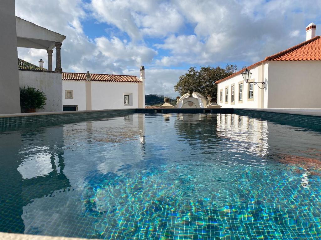 a swimming pool in the middle of a house at Cazal d'Oliveira in Granja