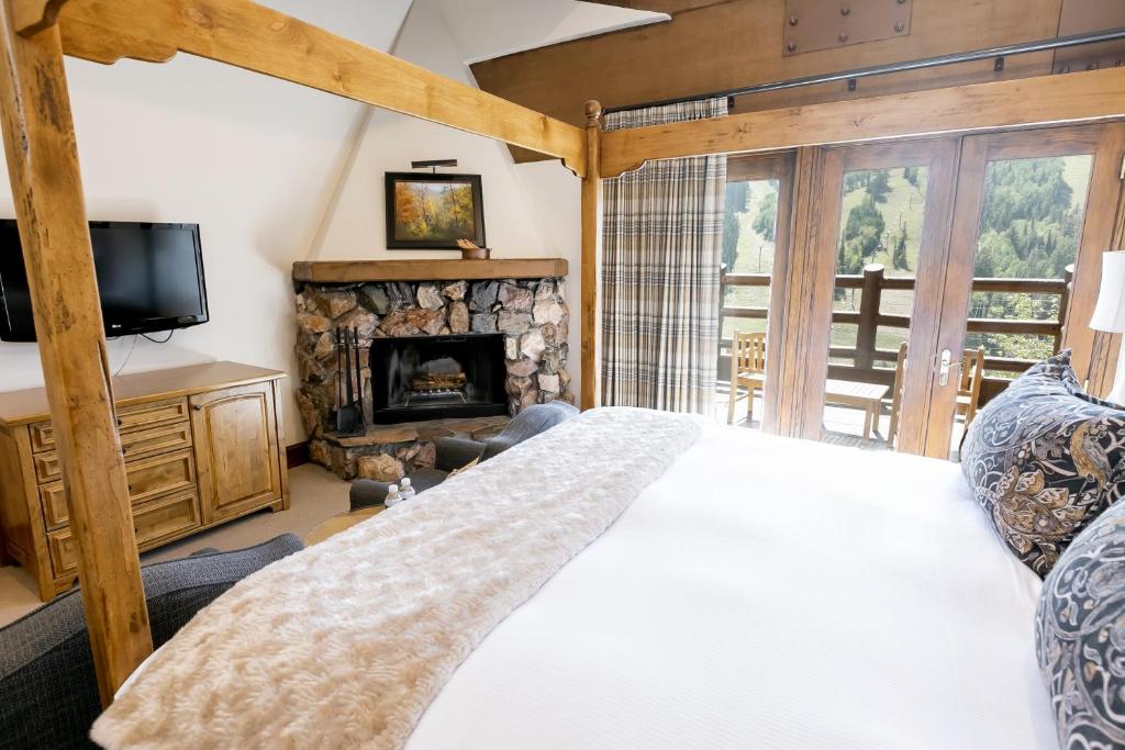 a bedroom with a bed and a fireplace at Main Lodge Luxury King Room with Hot Tub Hotel Room in Park City