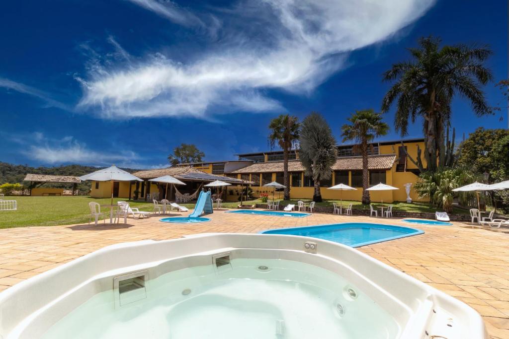 a large swimming pool with a resort at Hotel Fazenda Minas Real in Simão Pereira