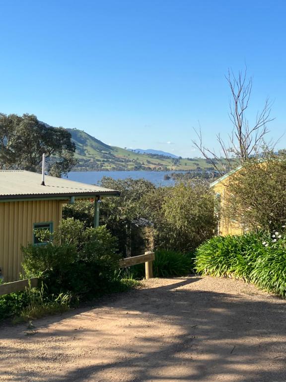 a house with a view of a body of water at Burnt Creek Cottages in Mansfield