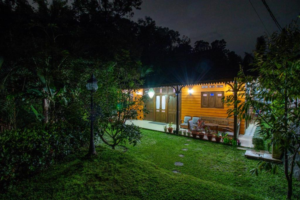 a house at night with a yard and a house at Nature staycation Escape From City, Belgareti Farm in Nangkabeurit