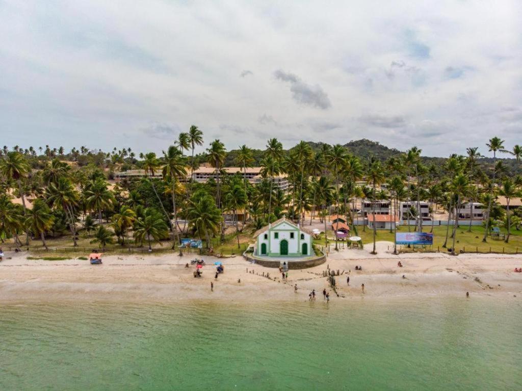 a group of people on a beach near the water at ECO RESORT PRAIA DOS CARNEIROS - Desfrute de uma estadia inesquecível in Tamandaré