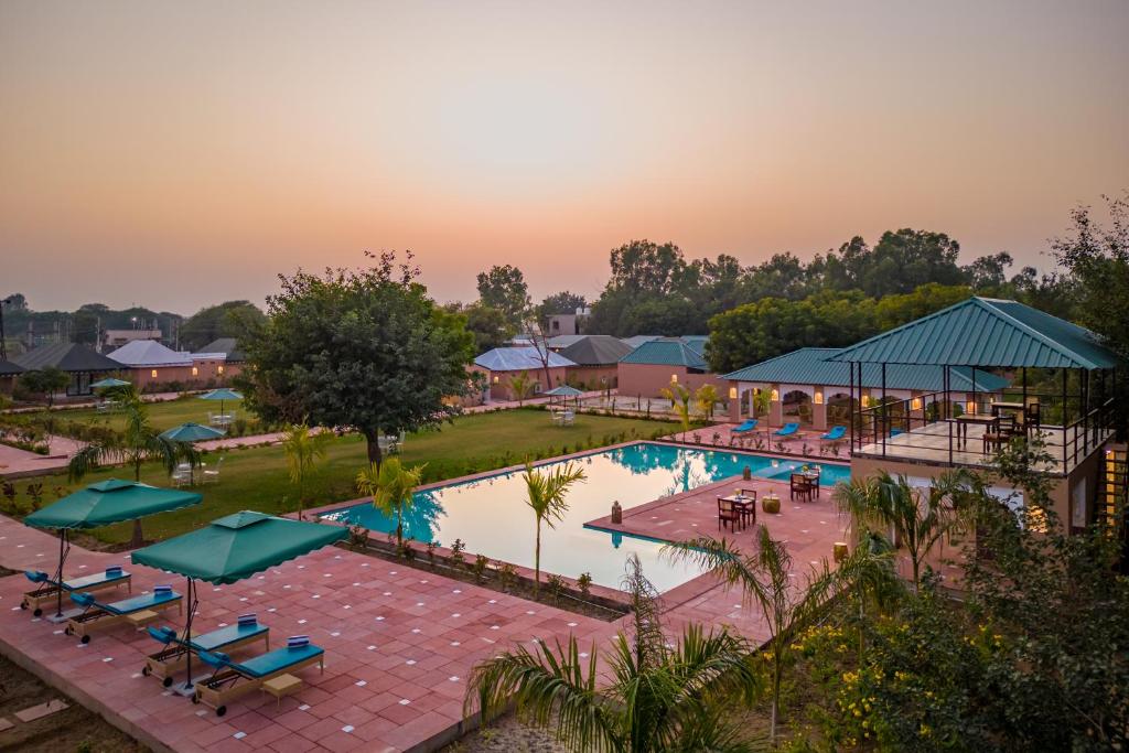 eine Aussicht auf einen Pool in einem Resort in der Unterkunft Aangan Resort Ranthambhore - A Private Pool Villa in Khilchīpur