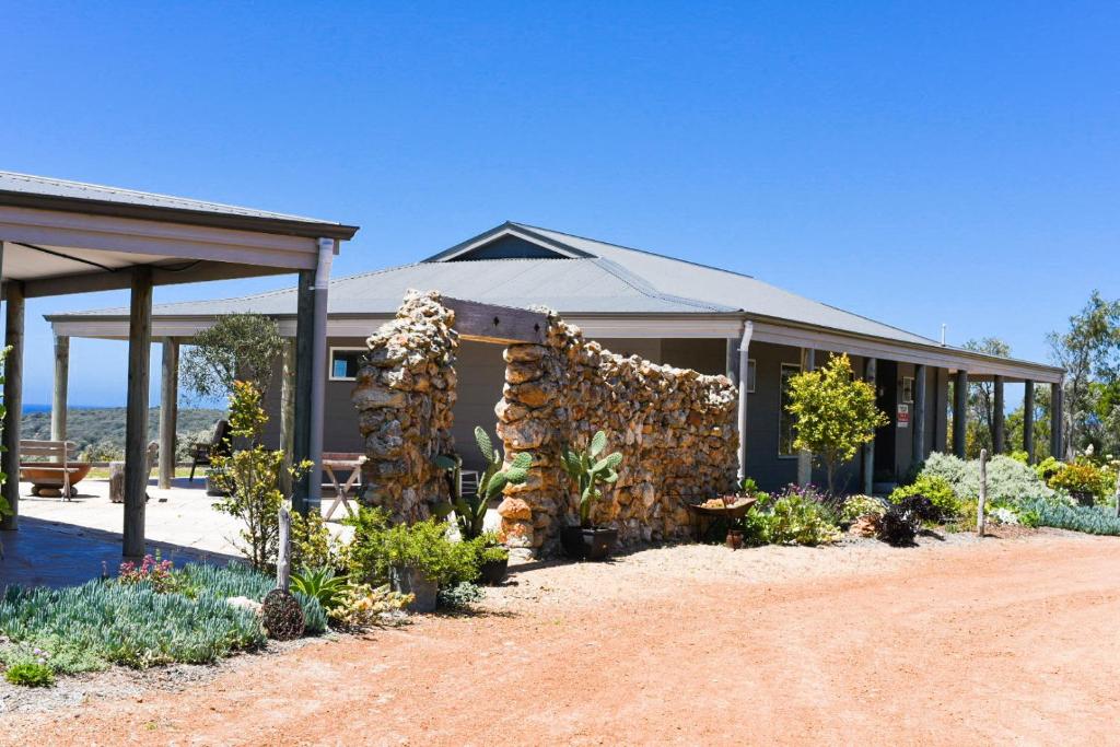 a house with a bunch of plants in front of it at Bremer Bay B&B in Bremer Bay