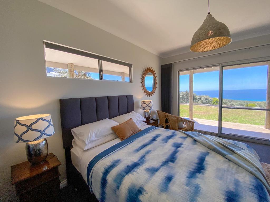 a bedroom with a bed with a view of the ocean at Bremer Bay B&B in Bremer Bay