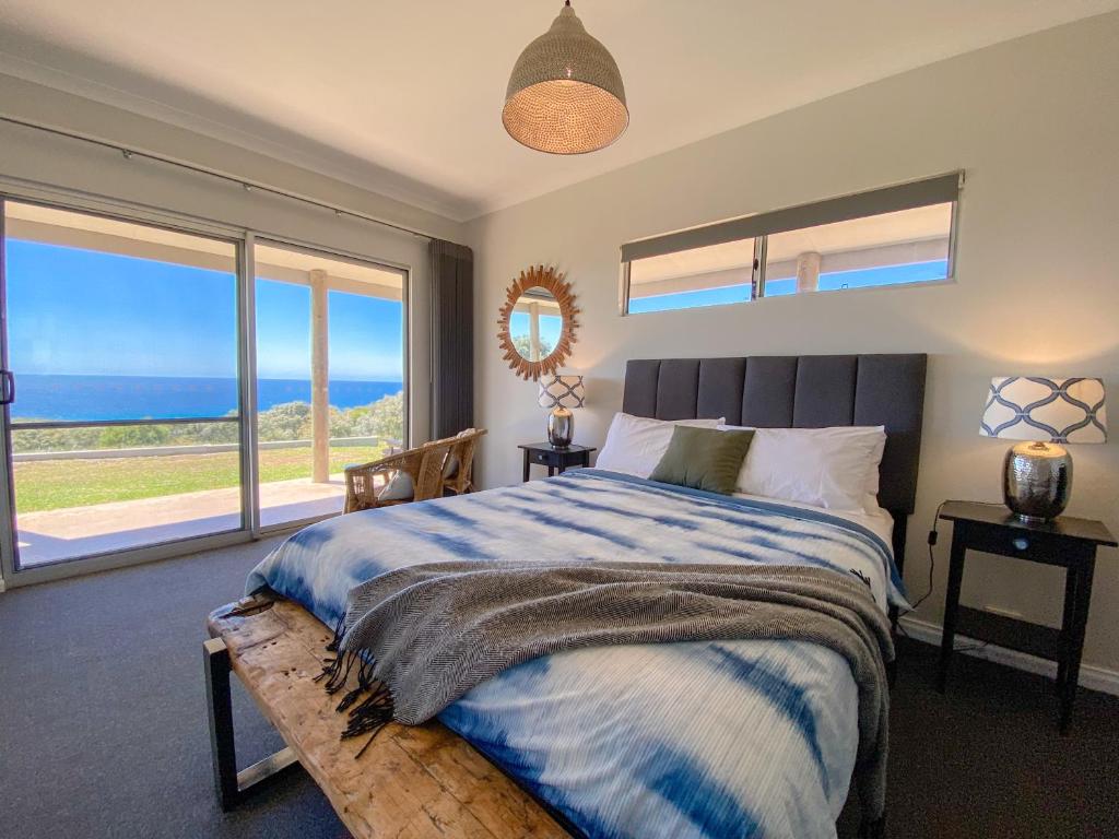 a bedroom with a bed with a view of the ocean at Bremer Bay B&B in Bremer Bay
