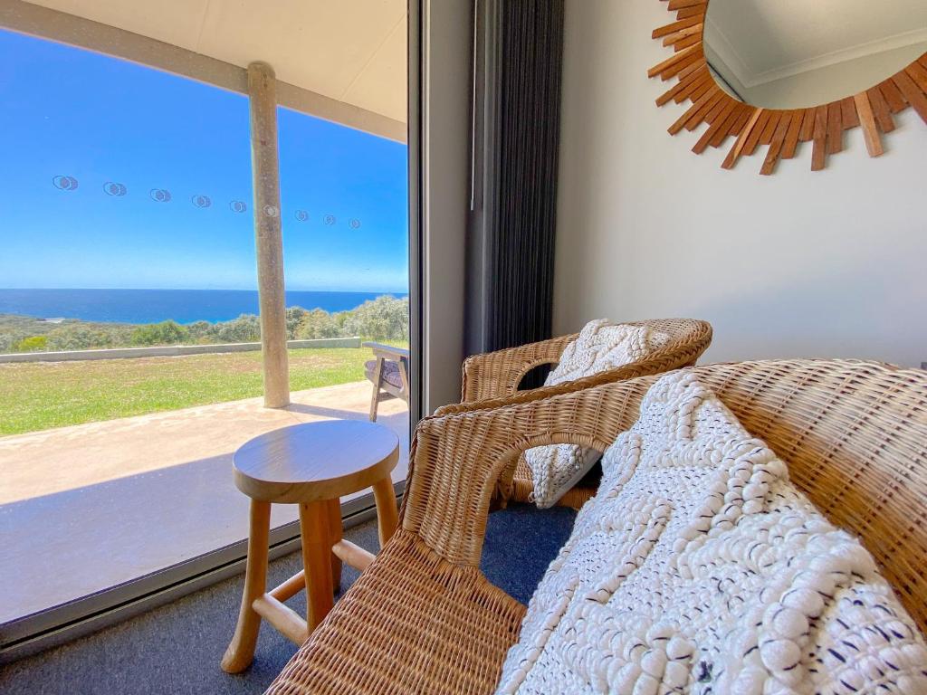 a bedroom with a bed and a view of the ocean at Bremer Bay B&B in Bremer Bay