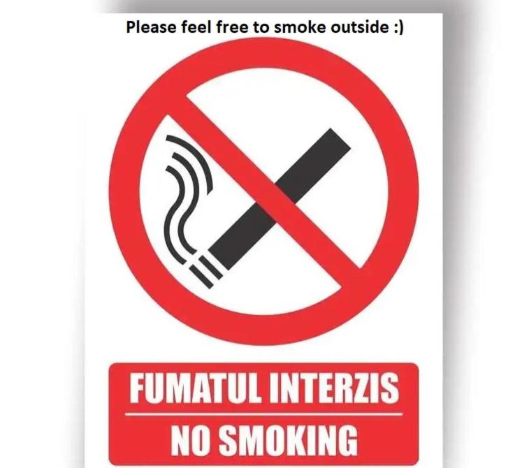 a sign with a no smoking sign on it at Apartament Andreas in Arad