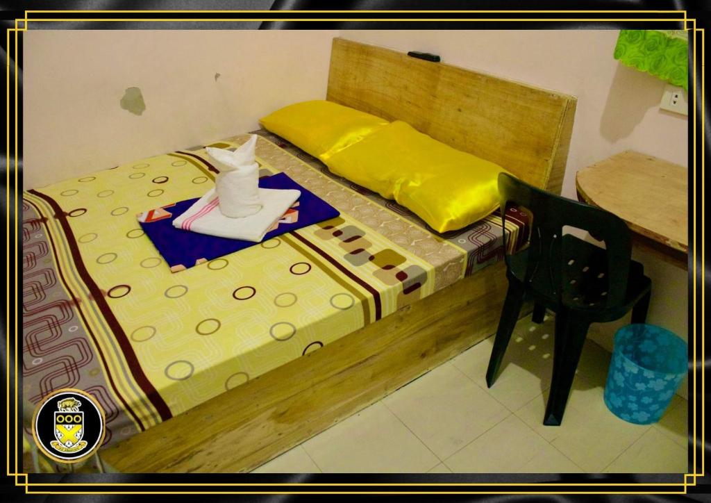 a model of a bed with a table and a chair at White Knights Dumaguete in Dumaguete