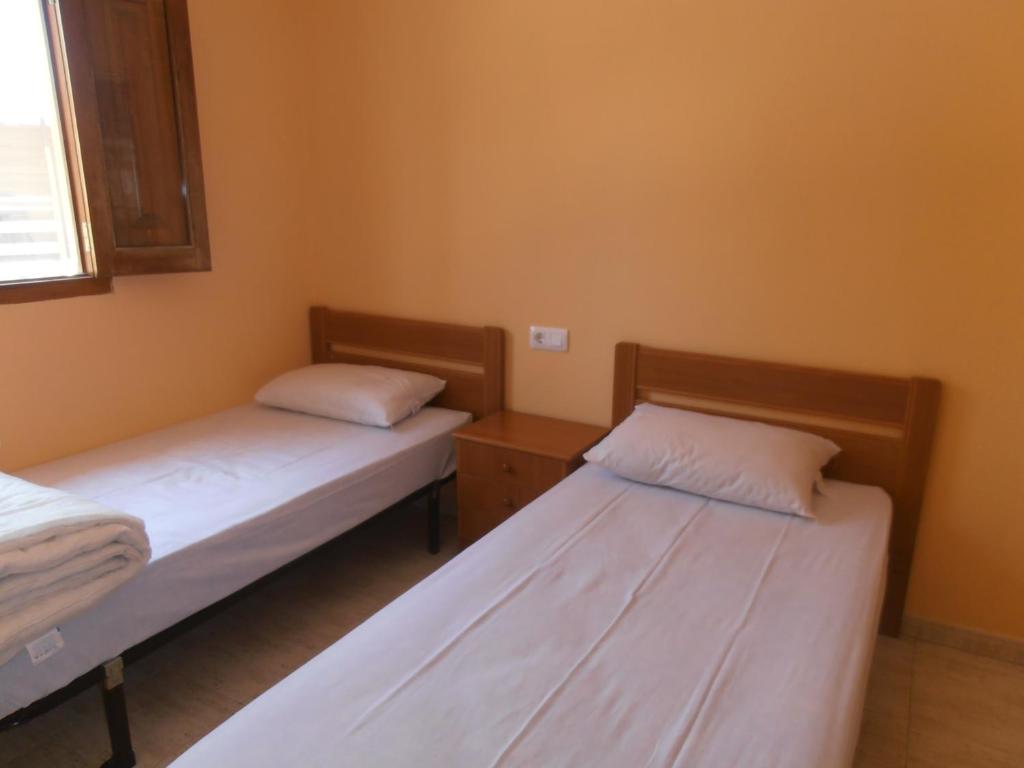 Una cama o camas en una habitación de Oasis Country Park