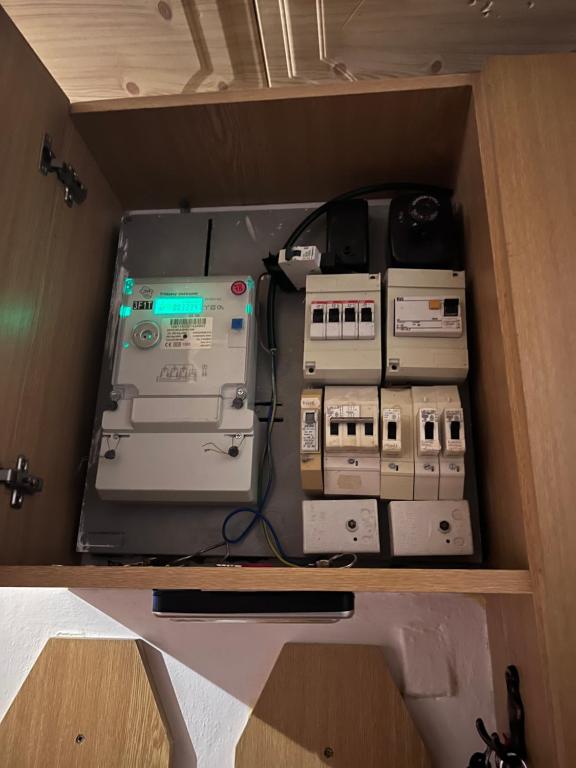 a box with several electronic equipment sitting on a shelf at Byt hruza in Prague