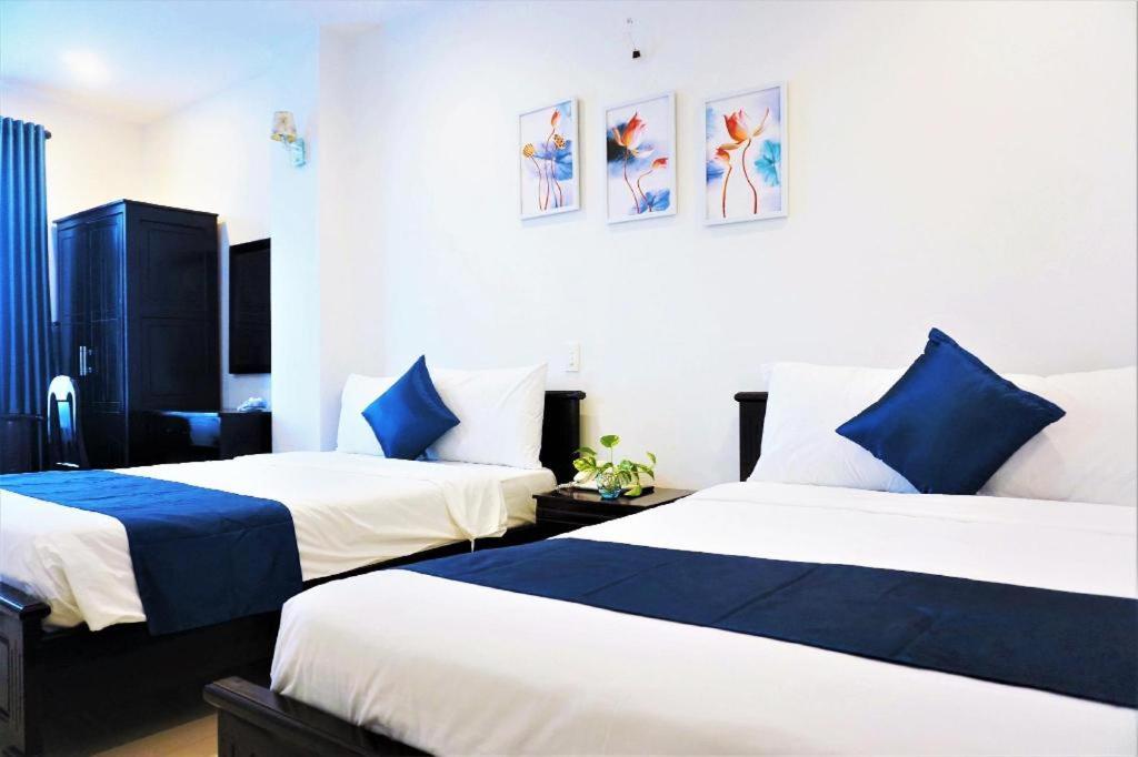 Postel nebo postele na pokoji v ubytování Tehana Beach Hotel Da Nang