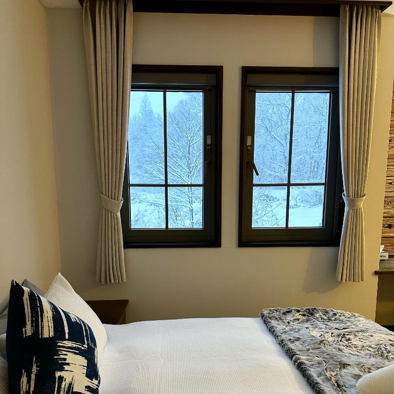 Postel nebo postele na pokoji v ubytování Legend Inn Myoko