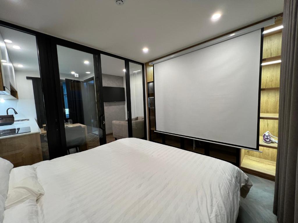 Giường trong phòng chung tại LE CIMENT - Apartment Hotel