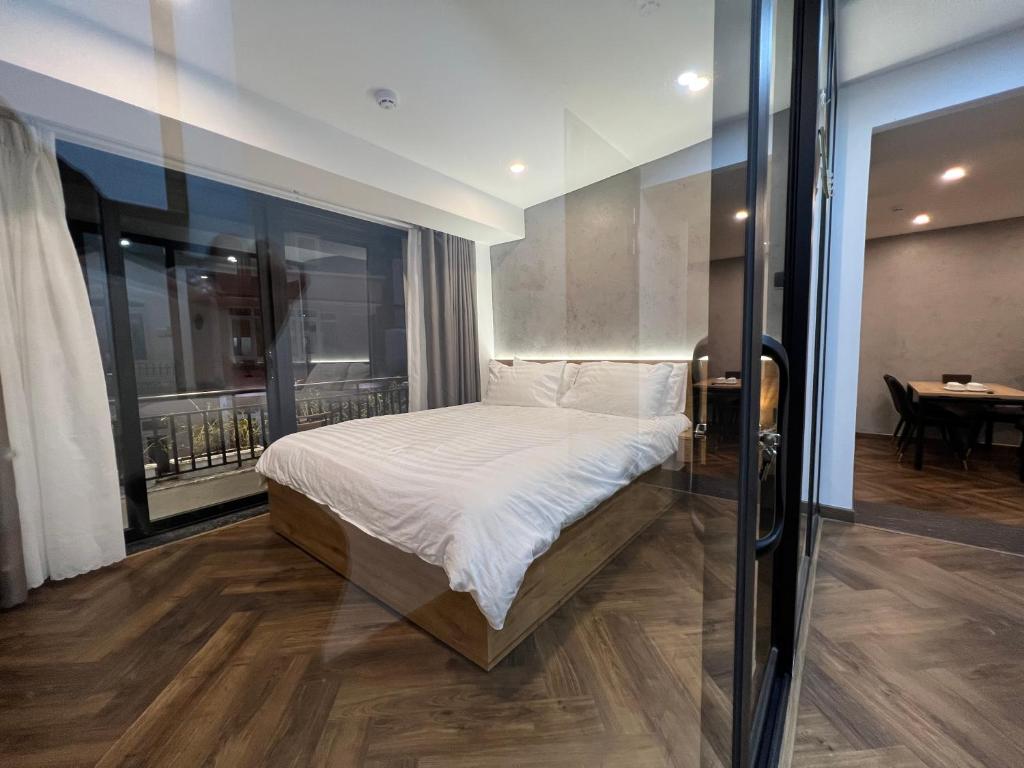 Giường trong phòng chung tại LE CIMENT - Apartment Hotel