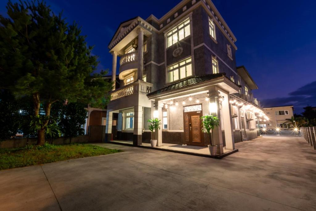 a large house with lights on the front of it at Romatic Venice Homestay in Luodong