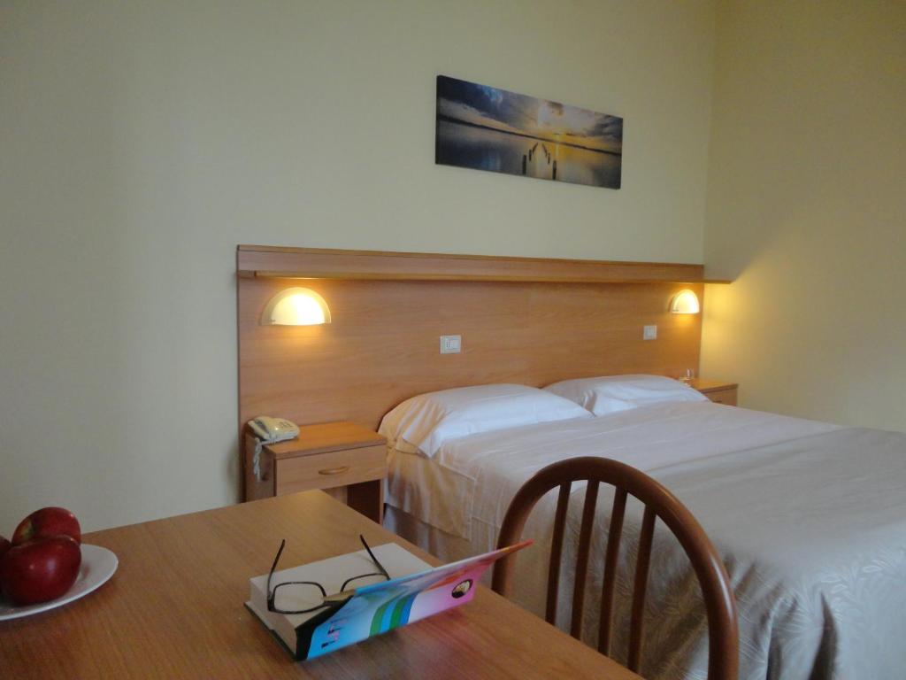 Posteľ alebo postele v izbe v ubytovaní Hotel Sacro Cuore
