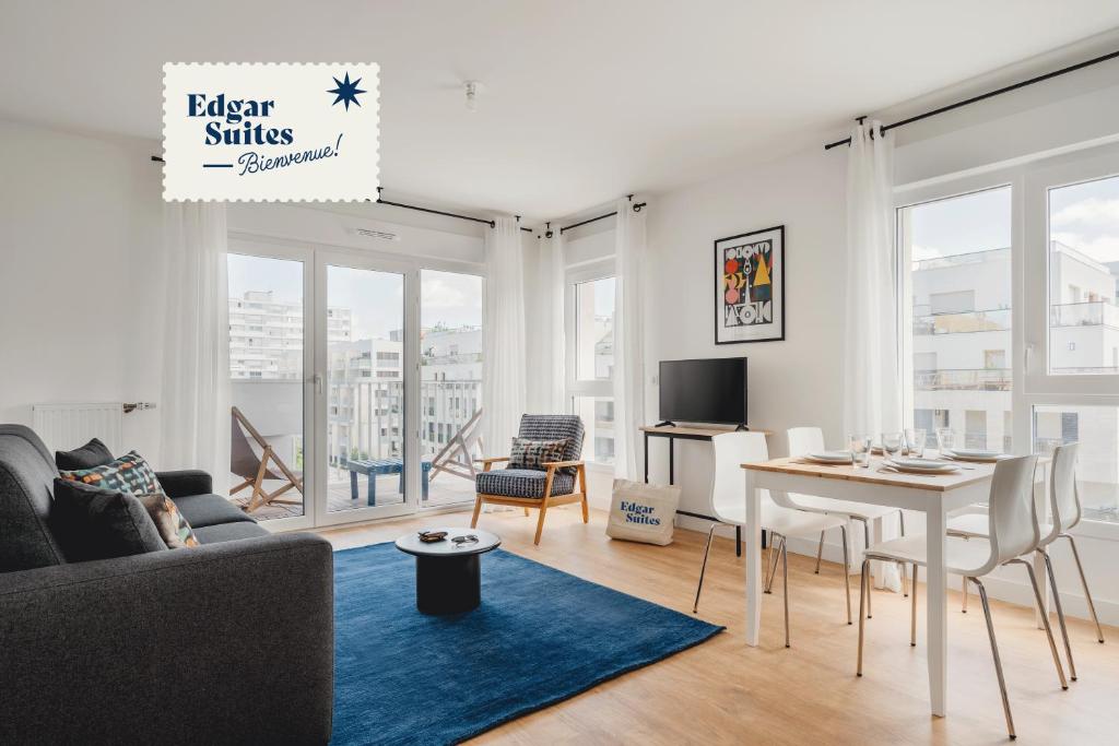 a living room with a couch and a table at Edgar Suites - Meudon-la-Forêt in Meudon