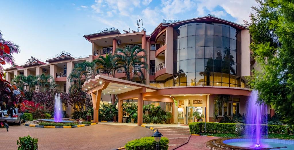 a building with a fountain in front of it at Mbale Resort Hotel in Mbale