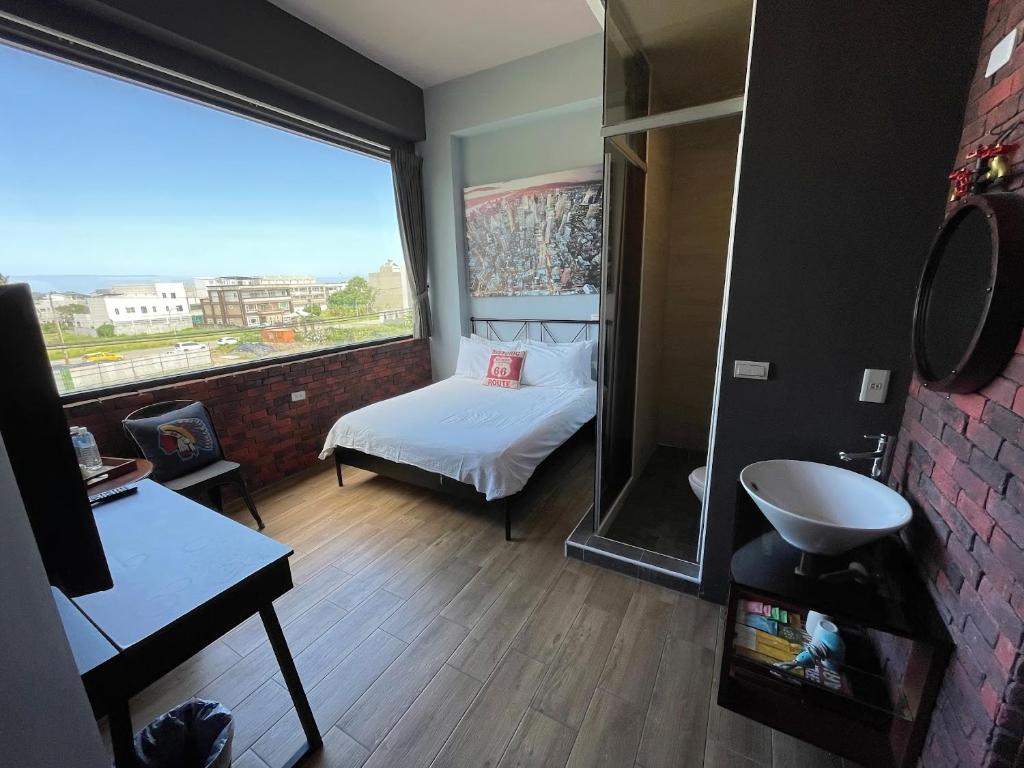 a bedroom with a bed and a window with a view at Lancasa Taitung in Taitung City