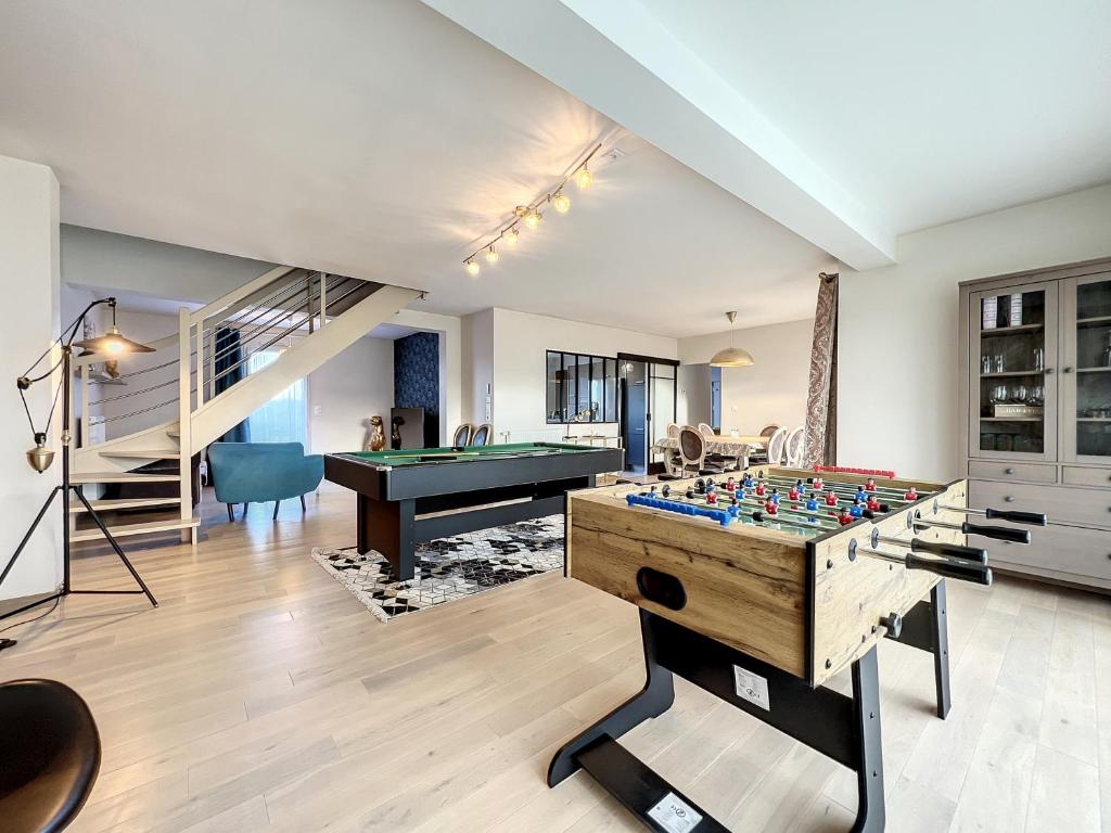 a living room with a foosball table and a pool table at VILLA BELLA VISTA - Proche Rennes - Billard - Baby-foot in Liffré