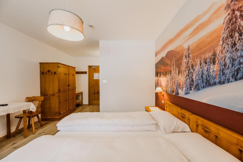 Postel nebo postele na pokoji v ubytování Hotel Garnì Rosengarten