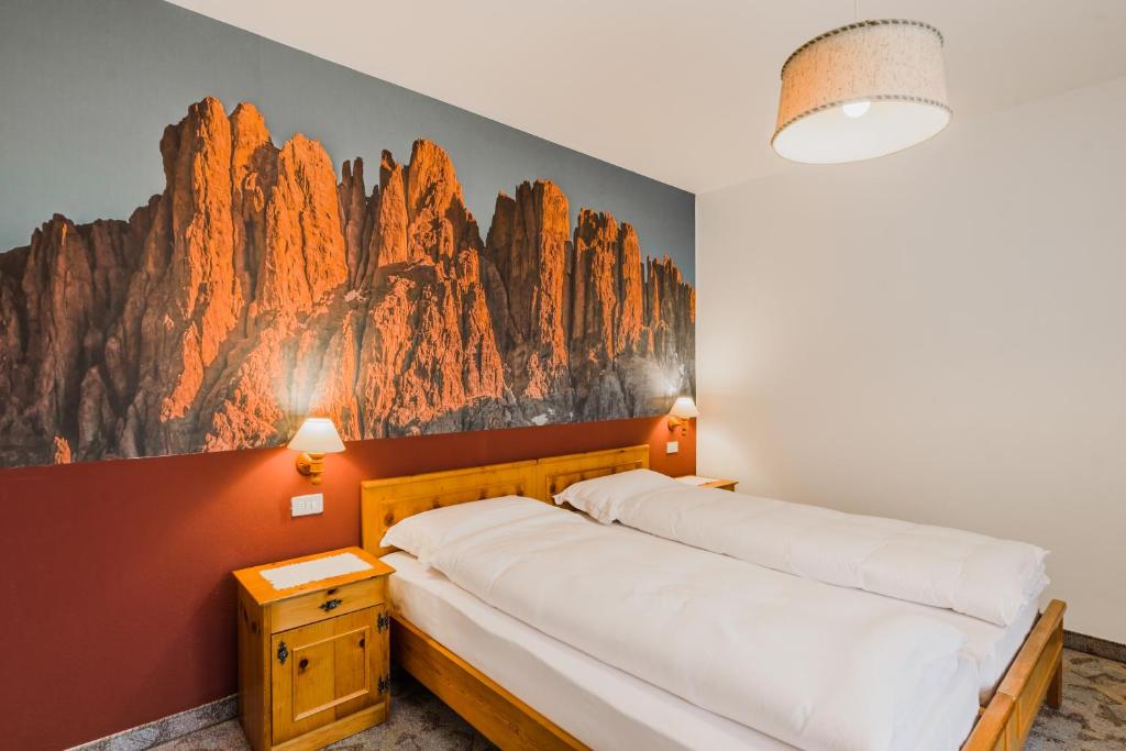 Postel nebo postele na pokoji v ubytování Hotel Garnì Rosengarten